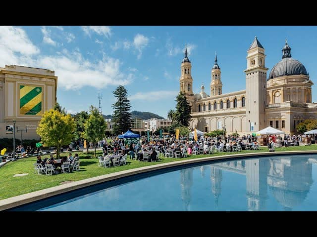 University of San Francisco outdoor event with tables, greenery, and stunning architecture.