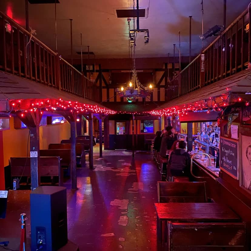 Cozy bar with warm lighting in New Century Theater, perfect for casual events and gatherings.