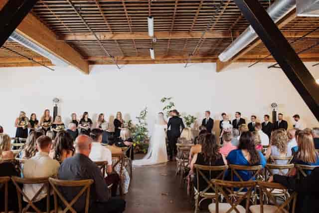Elegant wedding ceremony setup in BLOC VENUE with natural light and greenery.