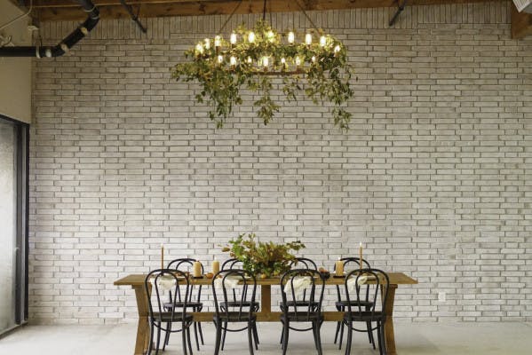Stylish BLOC VENUE room with wooden table, ideal for intimate meetings and private dinners.