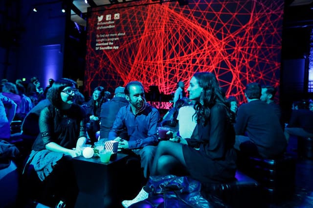 Vibrant networking event at SoundBox, Davies Symphony Hall with bold lighting and modern design.