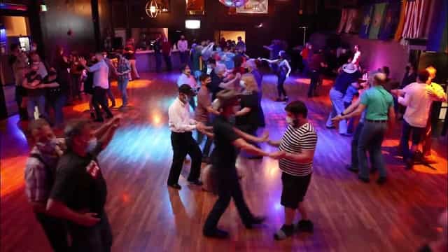 Lively dance floor in Sundance Saloon for social dance event and networking.