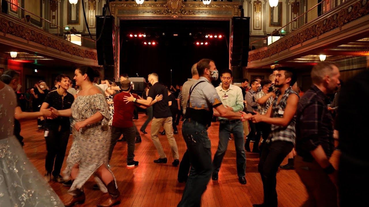 Vibrant dance event in Sundance Saloon's Main Ballroom with ornate architecture.