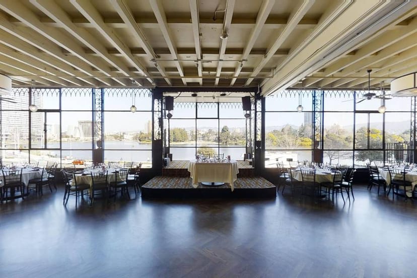 Spacious event venue with large windows, ideal for meetings and social gatherings.