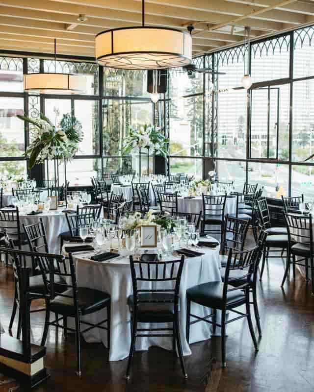 Elegant event space with round tables, ideal for weddings and corporate events.
