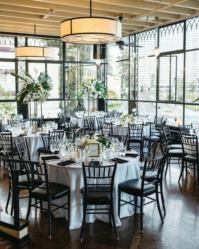 Elegant event space with round tables, ideal for weddings and corporate events.