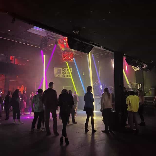 Vibrant event space at Power Exchange with dynamic lighting for social gatherings.