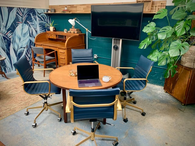Main Conference Room in PHOENIX with round table, ideal for meetings and brainstorming sessions.