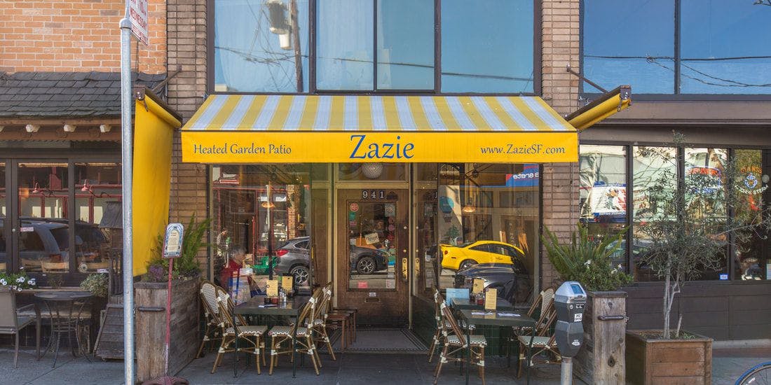 Heated garden patio at Zazie with yellow awning, ideal for casual gatherings and events.