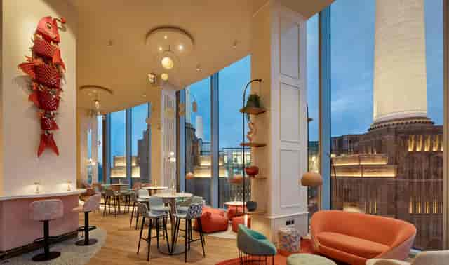 Stylish JOIA Restaurant event space with large windows, ideal for networking and receptions.