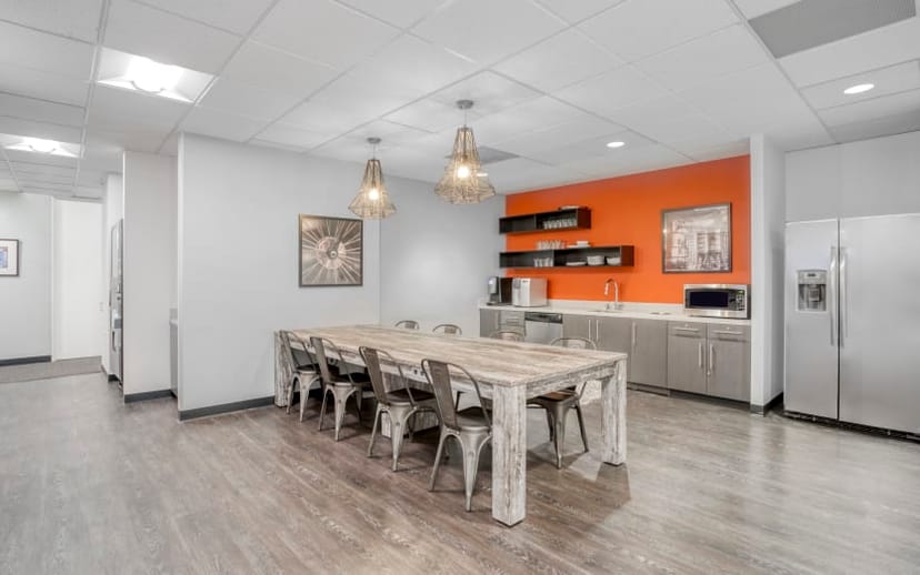 Modern conference room with wooden table, ideal for team meetings and events.