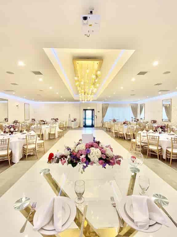 Elegant event space at Elli Banquet Hall with floral centerpieces, perfect for weddings and corporate events.