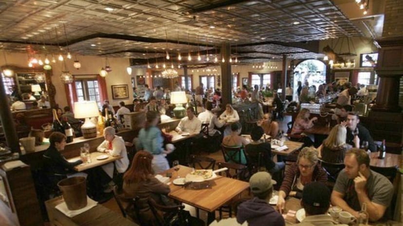 Bustling Tin Roof Bistro patio with cozy seating for networking events and casual gatherings.