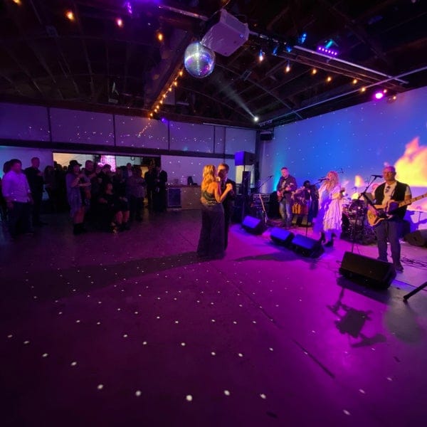 Vibrant Rose Room event space with live band, ideal for networking and celebrations.