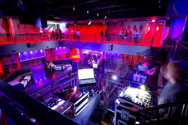 Vibrant Rose Room event space with stylish seating, perfect for parties and corporate events.