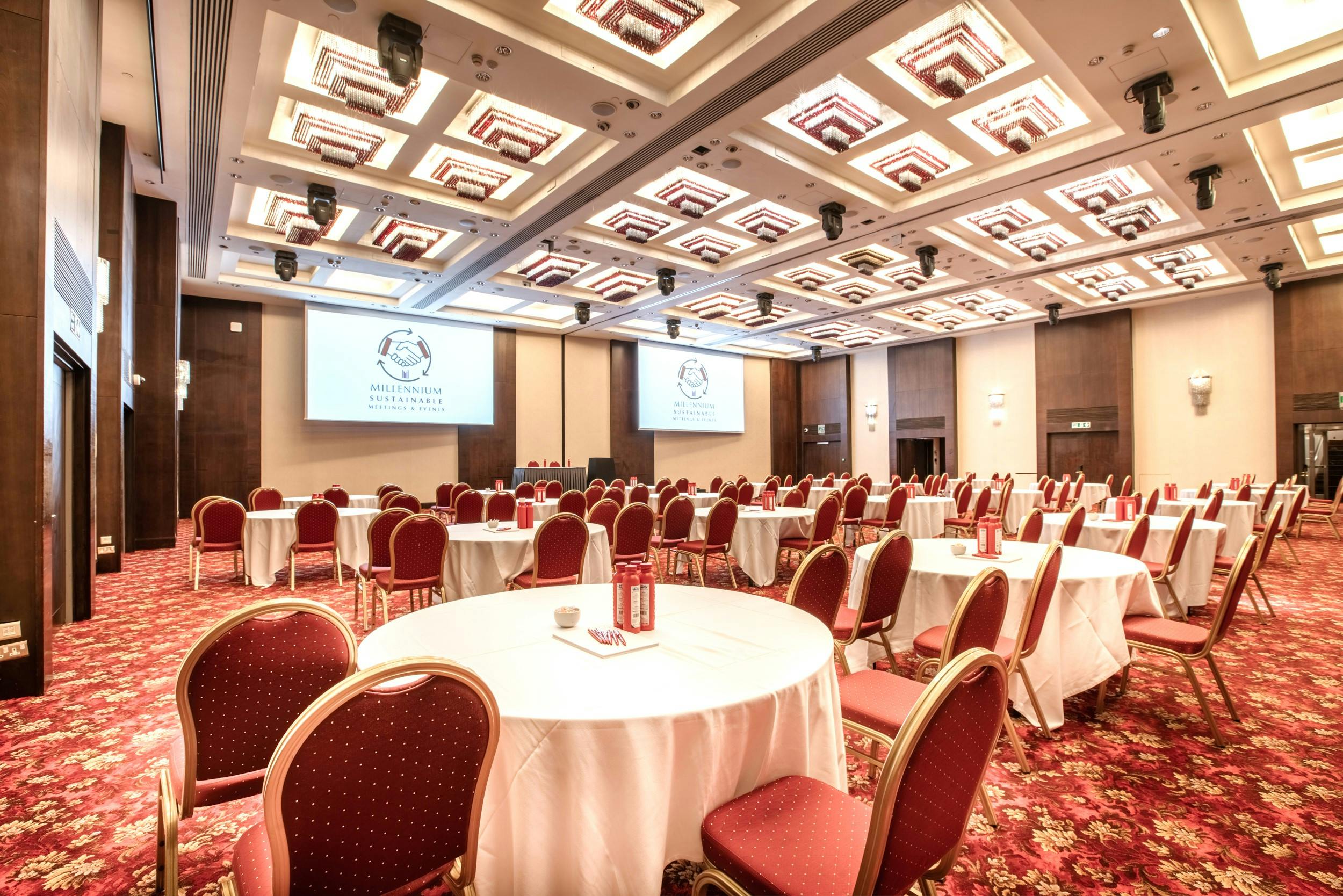 Convention promotion package in London with round tables and red chairs for corporate events.