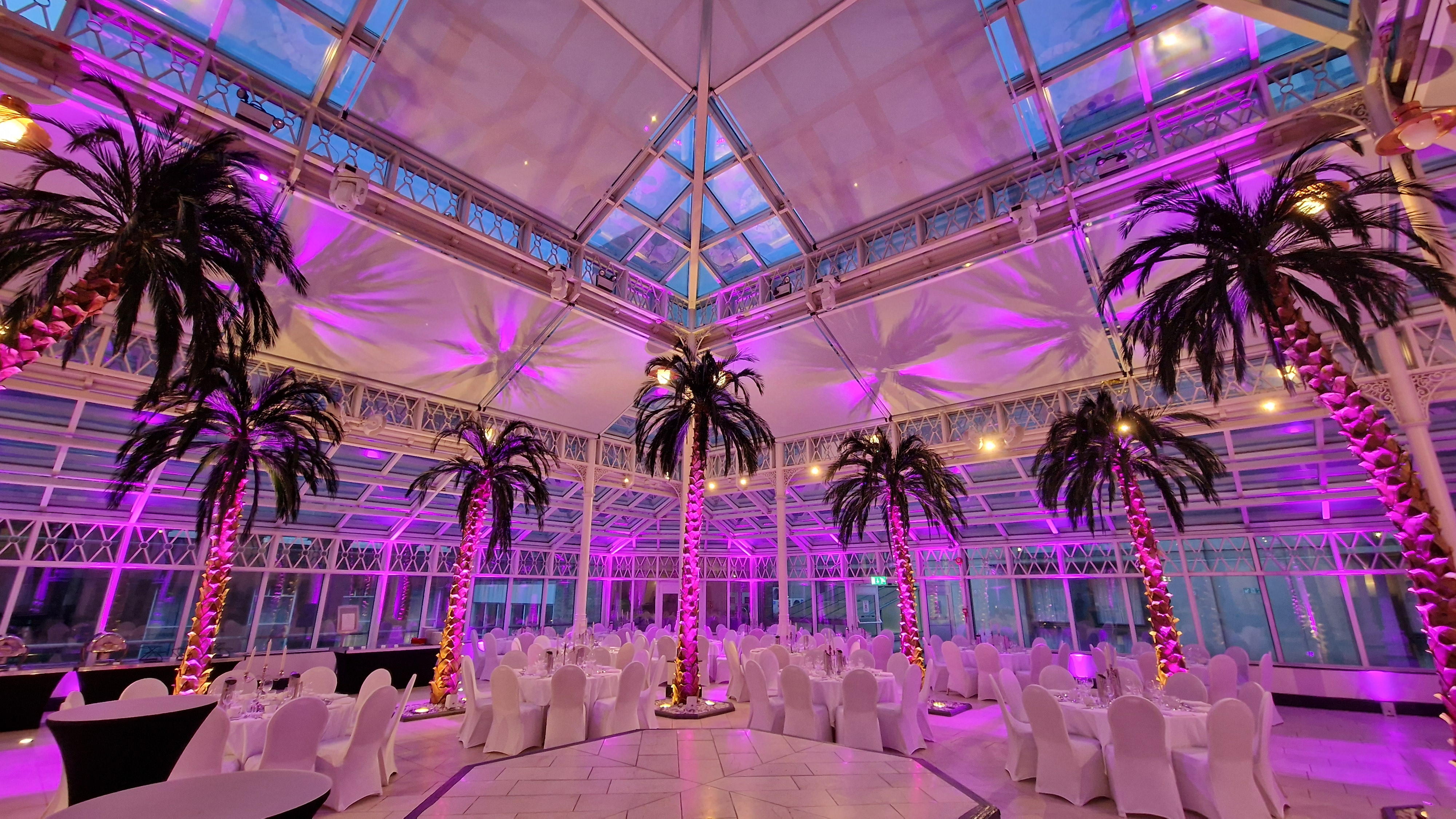 Elegant event space with white chairs and glass ceiling at Millennium Gloucester, London. - Banner