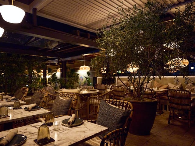 Outdoor patio dining space with elegant table settings for events and gatherings.
