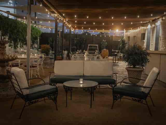 Outdoor patio lounge with soft lighting, ideal for networking and casual meetings.