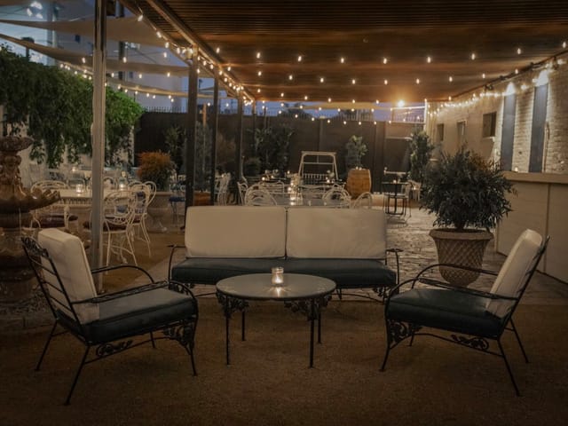Outdoor patio lounge with soft lighting, ideal for networking and casual meetings.