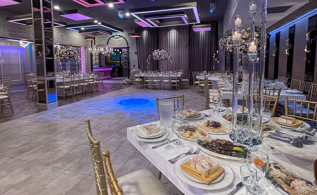 Elegant banquet hall with fine dining setup, perfect for weddings and corporate events.