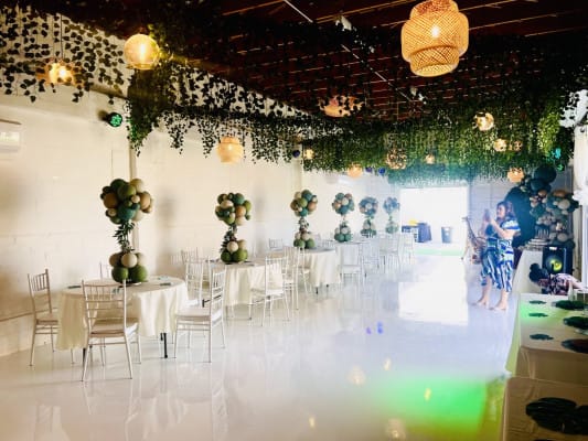 Elegant KUE Ballroom with round tables, balloon centerpieces for events and celebrations.