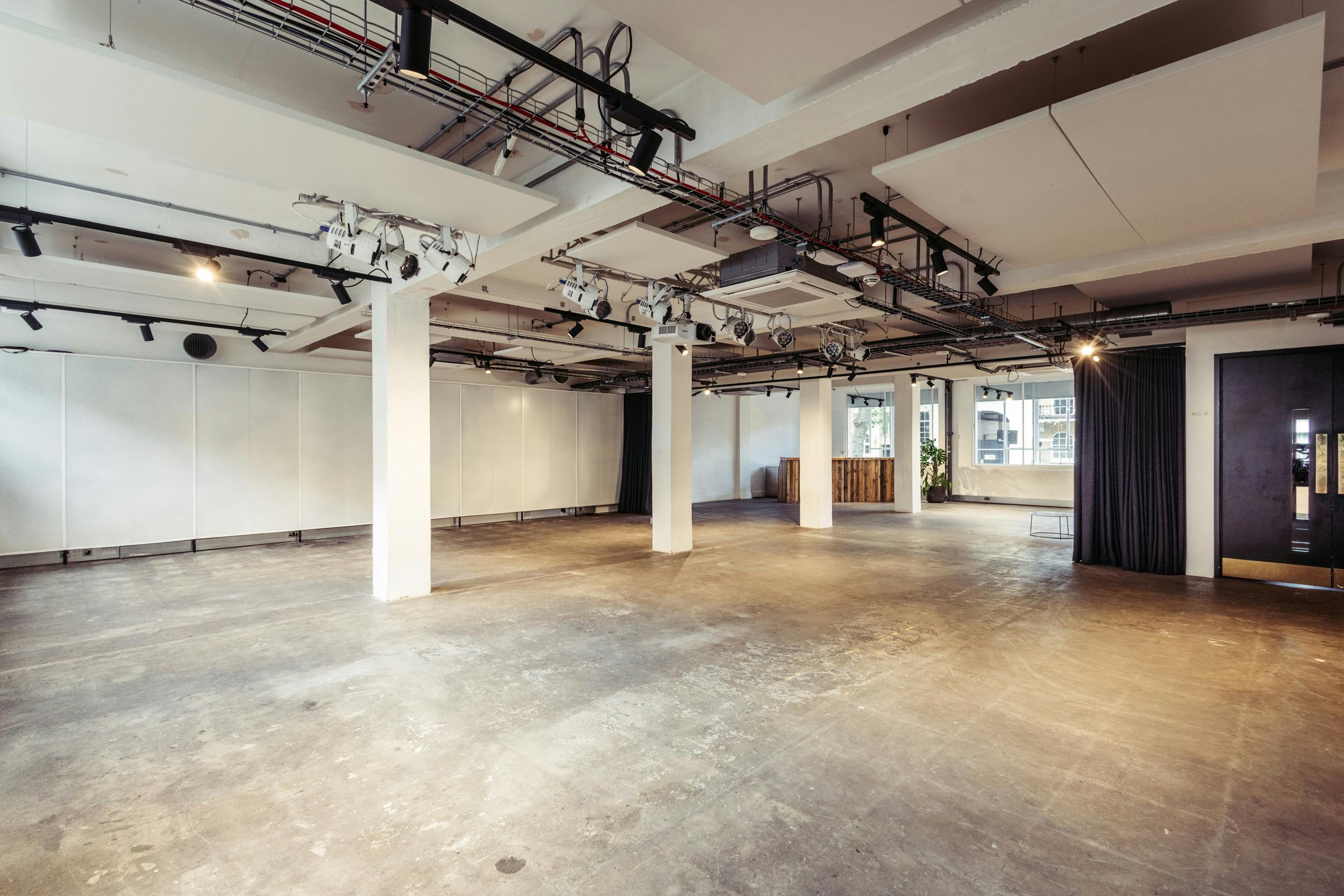 Versatile event space with natural light, ideal for workshops and networking events.