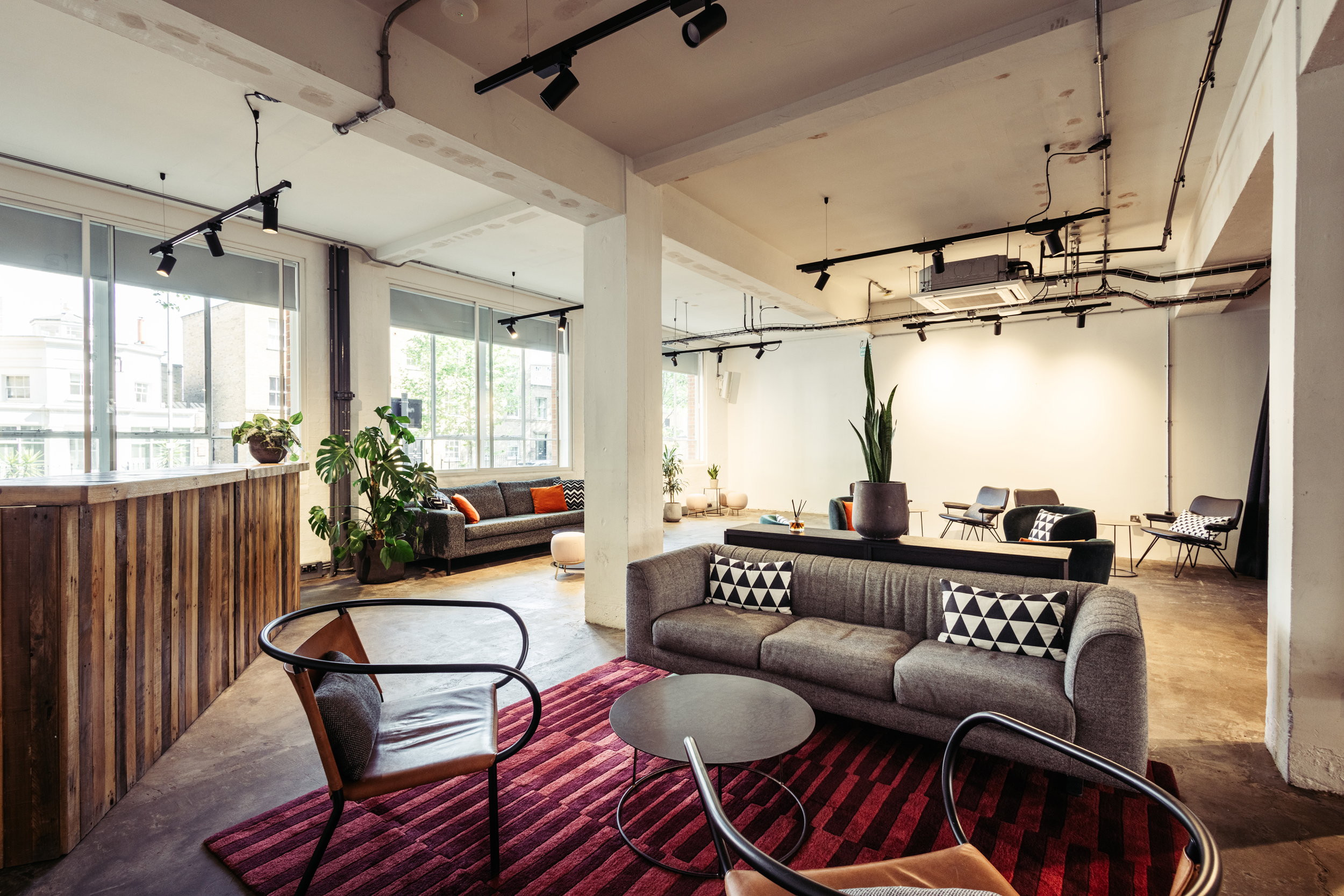 Modern event space with natural light and stylish furnishings for meetings and networking. - Banner