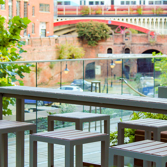 Stylish outdoor event space at The Wharf with modern seating and scenic views. - Banner