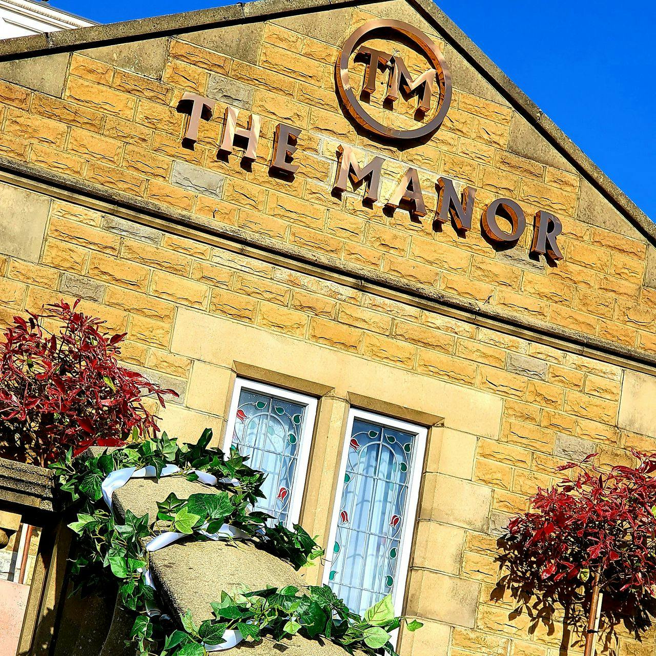 Charming Manor Leeds venue with warm stone facade, perfect for weddings and events.