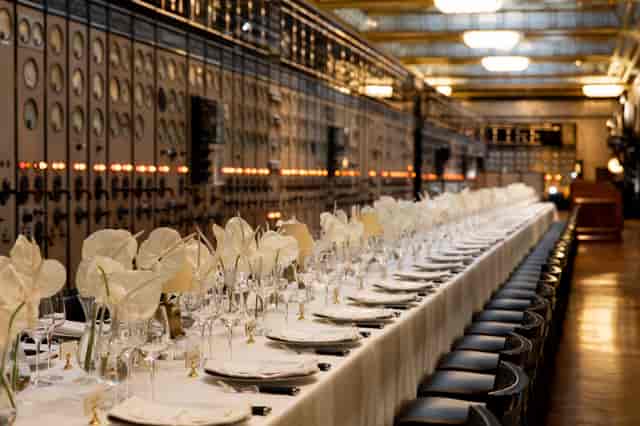 Elegant dining setup in Battersea Power Station's Control Room A for corporate events.