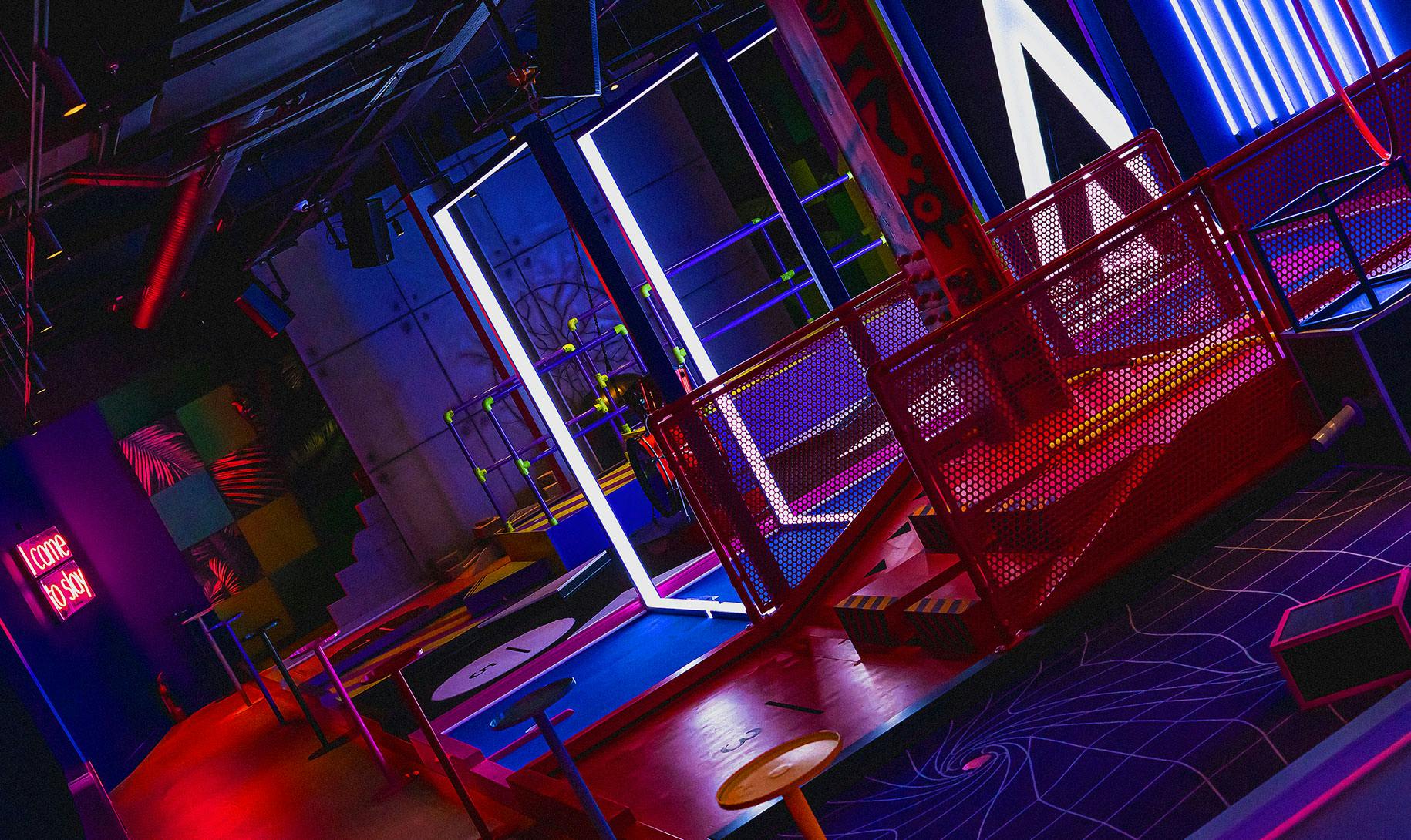 Vibrant B-Side event space with colorful lighting for team-building and social gatherings.
