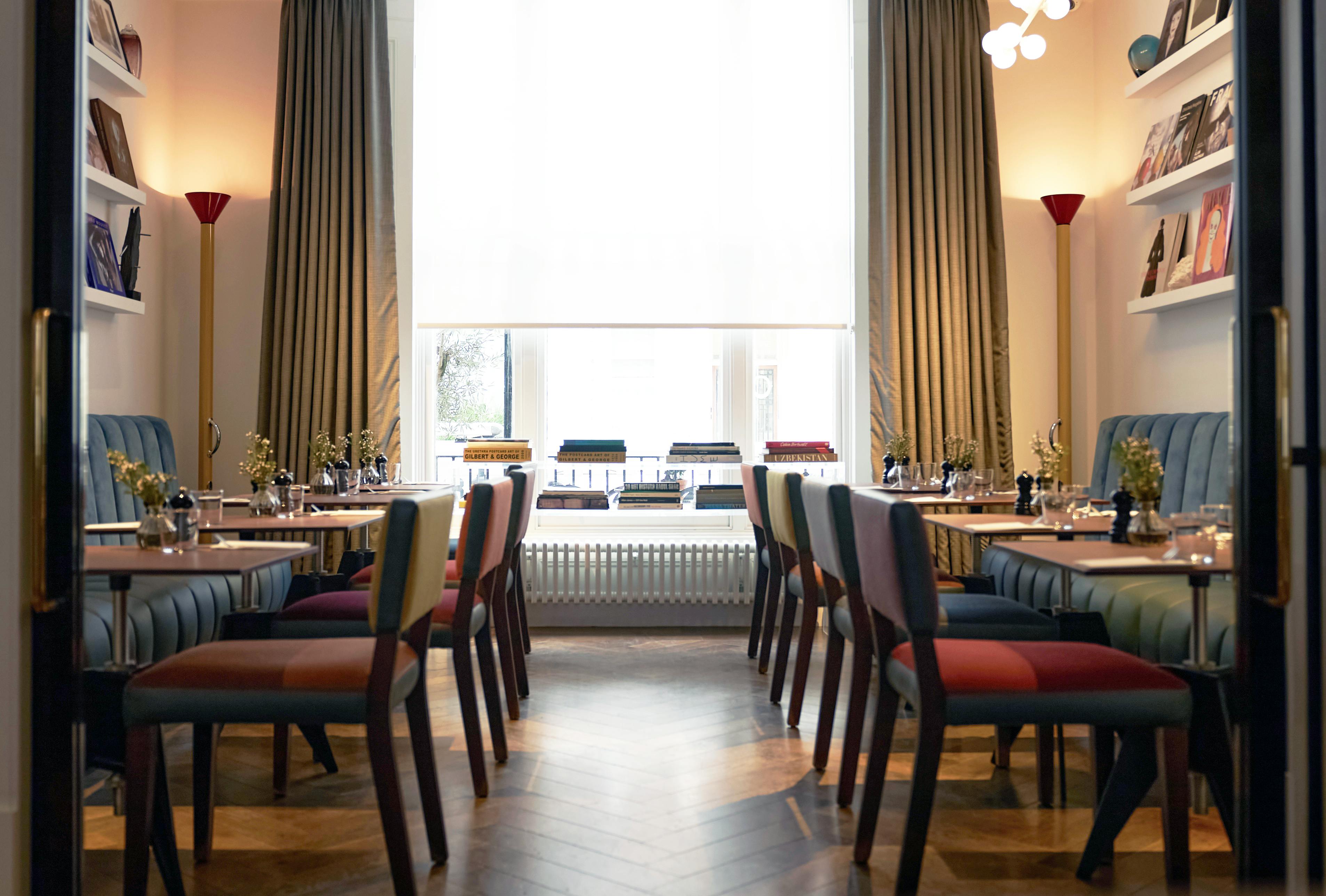 Henderson Dining Room at The Laslett: stylish meeting space with colorful chairs for workshops.