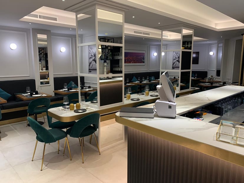 Elegant restaurant venue with sleek bar, perfect for intimate meetings and events.