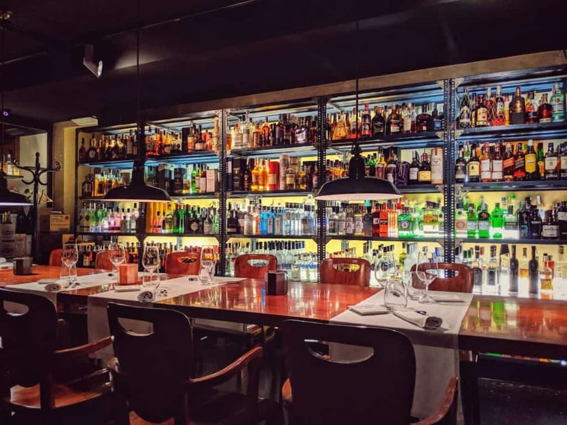 Stylish speakeasy bar with warm lighting for intimate gatherings and networking events.