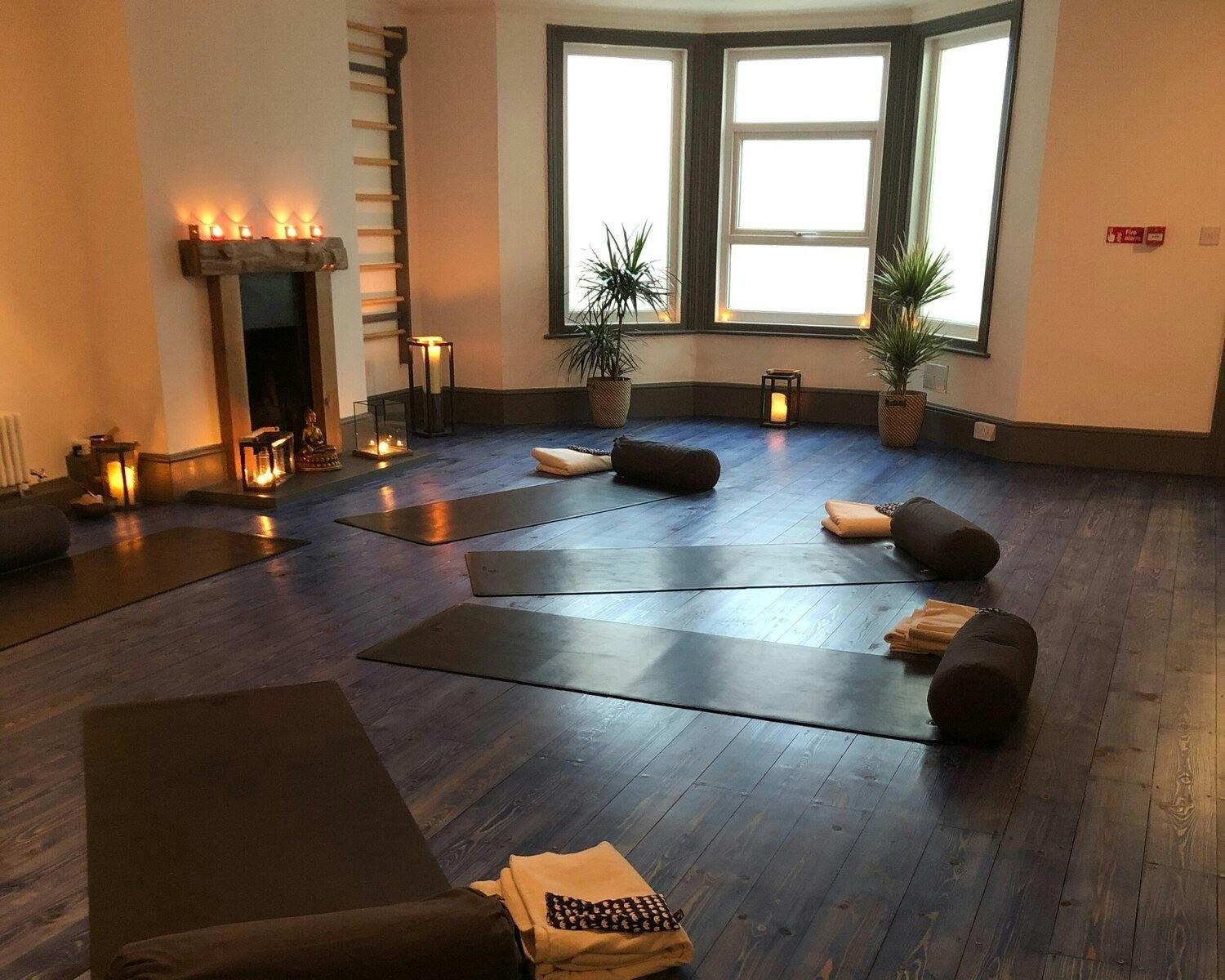Serene yoga studio with mats, perfect for wellness retreats and mindfulness workshops.