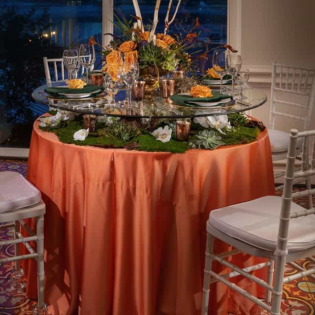 Chiavari chairs at cocktail hour with vibrant tablecloth for upscale weddings and events.