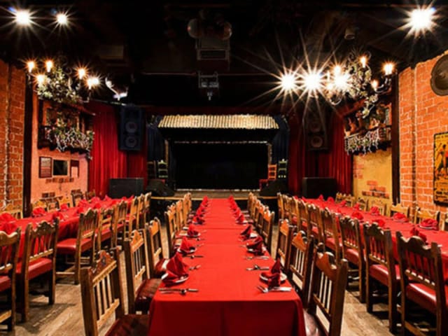 Vibrant banquet setup at El Cid Sunset bar with red tablecloths for events.