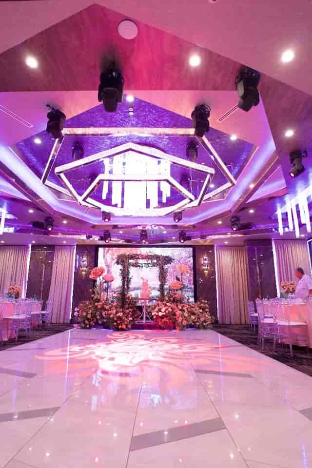 Corporate event setup with elegant lighting and floral arrangements in Bellaj Banquet Hall.