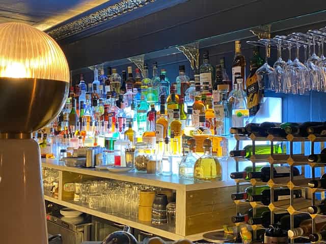 Vibrant bar setup with colorful liquor bottles for networking events and social gatherings.