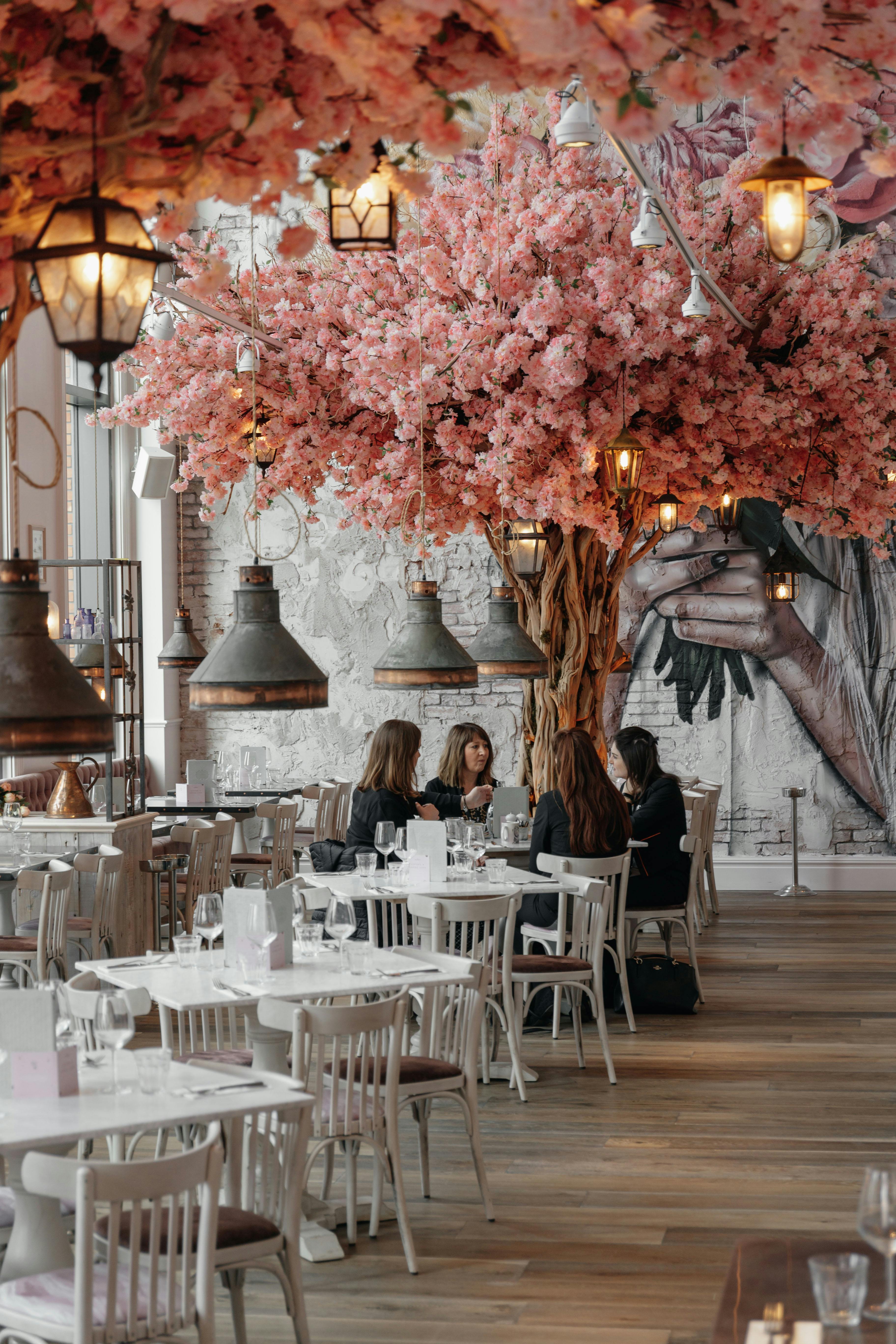 Stylish restaurant venue with cherry blossom tree, perfect for intimate events and gatherings.