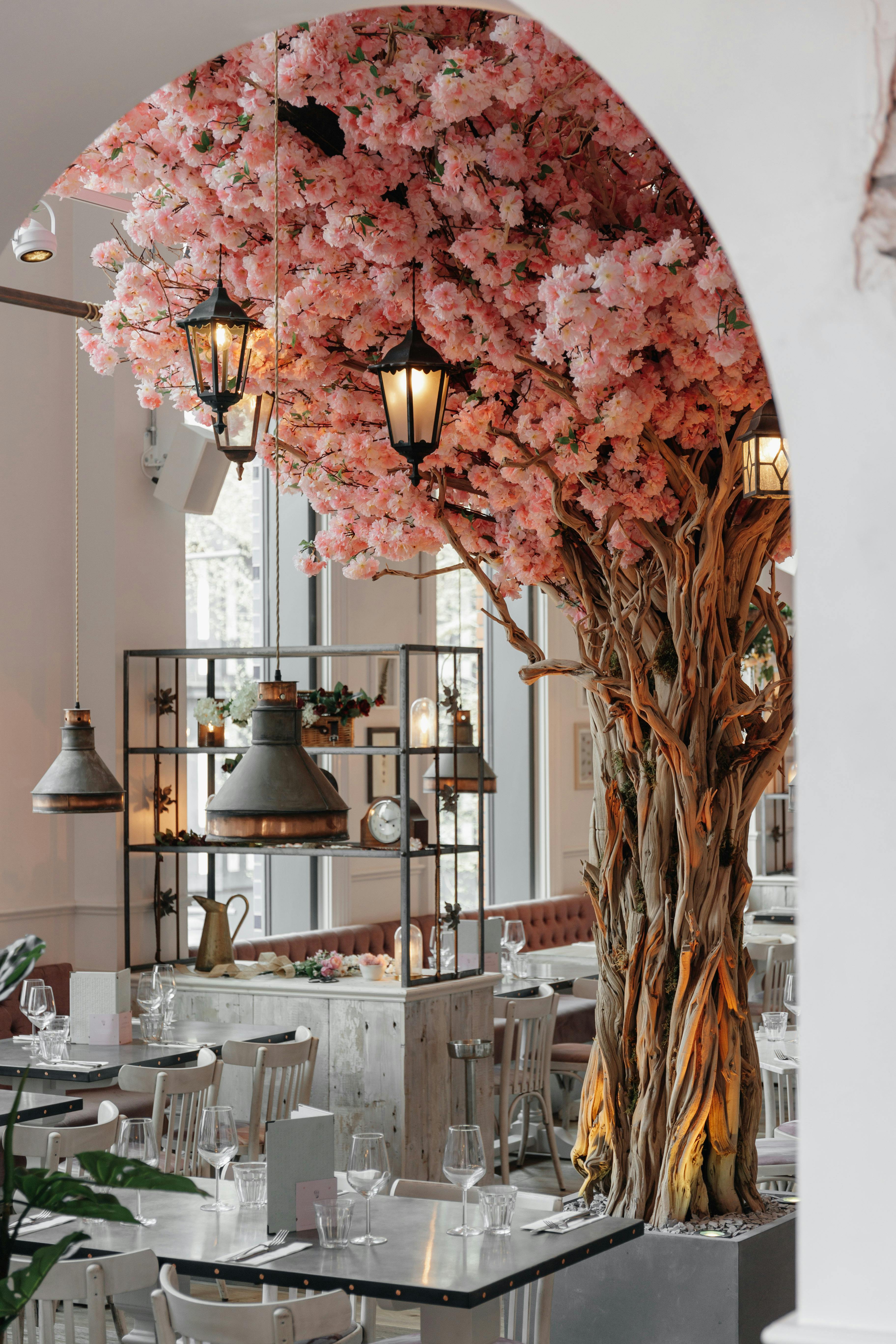 Elegant event space with cherry blossom centerpiece in The Florist, Watford. Perfect for gatherings.