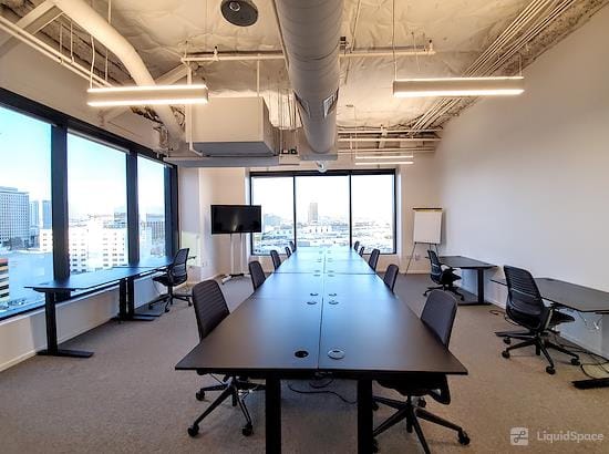 Modern meeting room with conference table and natural light at Overland Avenue Meeting Center.