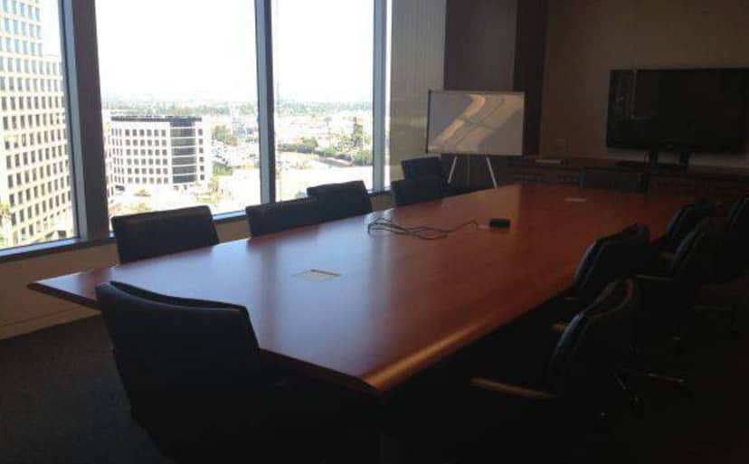 Modern conference room in Los Angeles with large table and natural light for meetings.