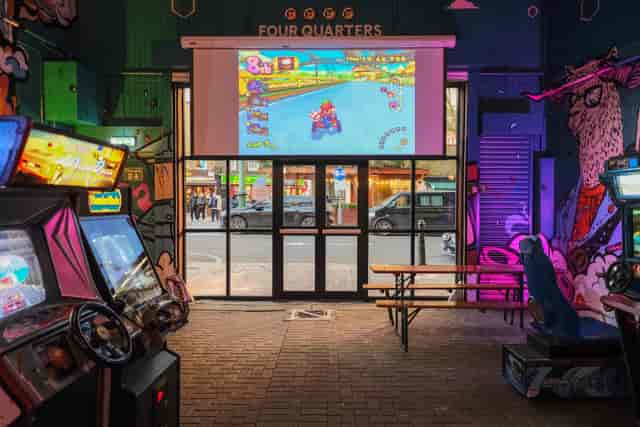 High-energy corporate event venue with gaming setup for team building and social mixers.