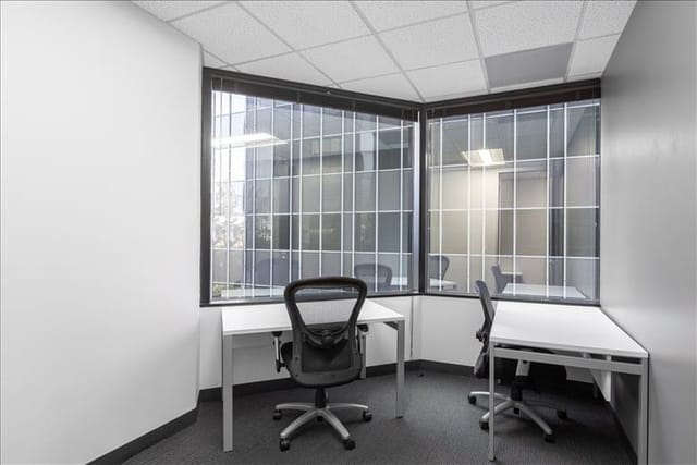 Minimalist meeting space with large windows for team discussions at Suite #200, 303 N Glenoaks.
