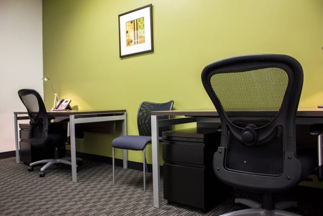 Modern minimalist workspace with ergonomic chairs for collaborative meetings.