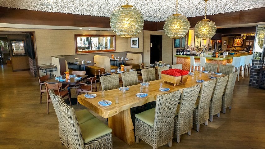 Private dining space with elegant lighting for intimate meetings at The Tangerine Room.