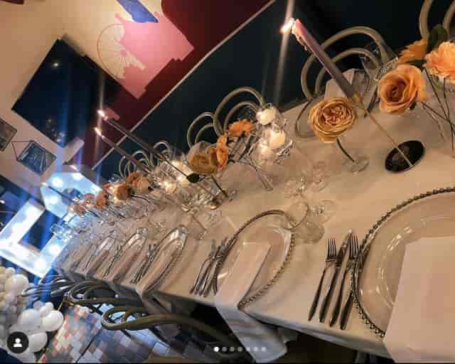 Elegant dining table with floral centerpieces for upscale events in The Furnace.