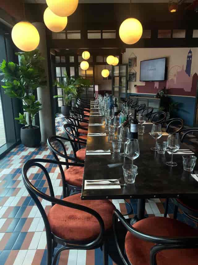 Elegant long dining table setup for corporate dinner in The Furnace venue.